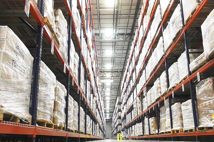 aisle of stacked inventory in a warehouse