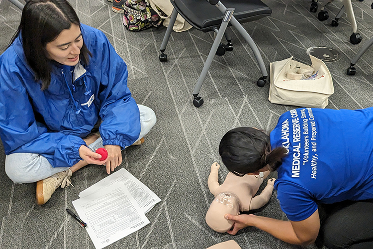 MRC staff conducting CPR training on infant-like training doll
