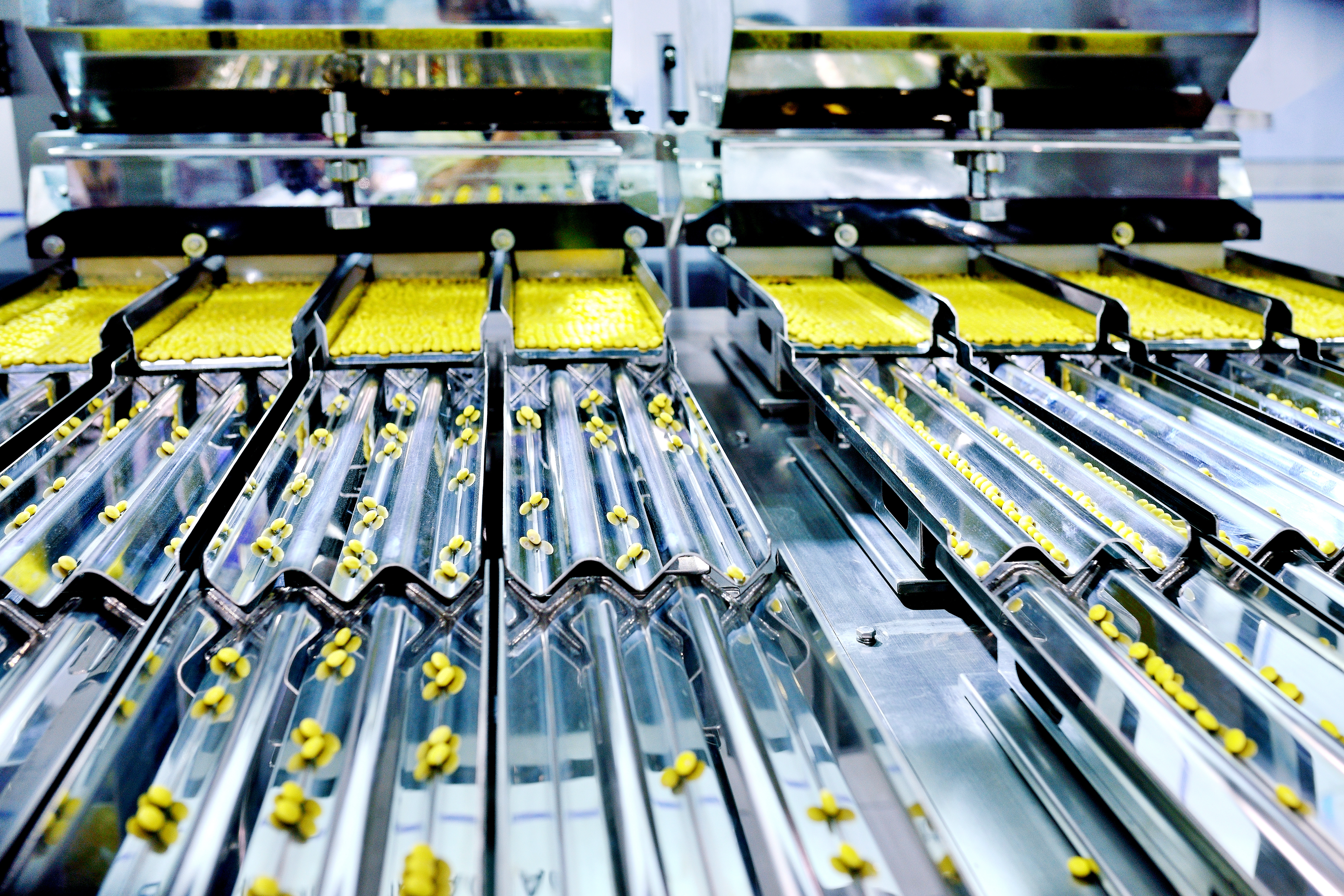 Yellow pills on a manufacturing rack