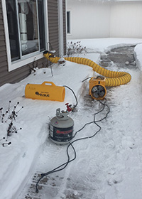 image of an propane heater attached to a home in snowy Michigan