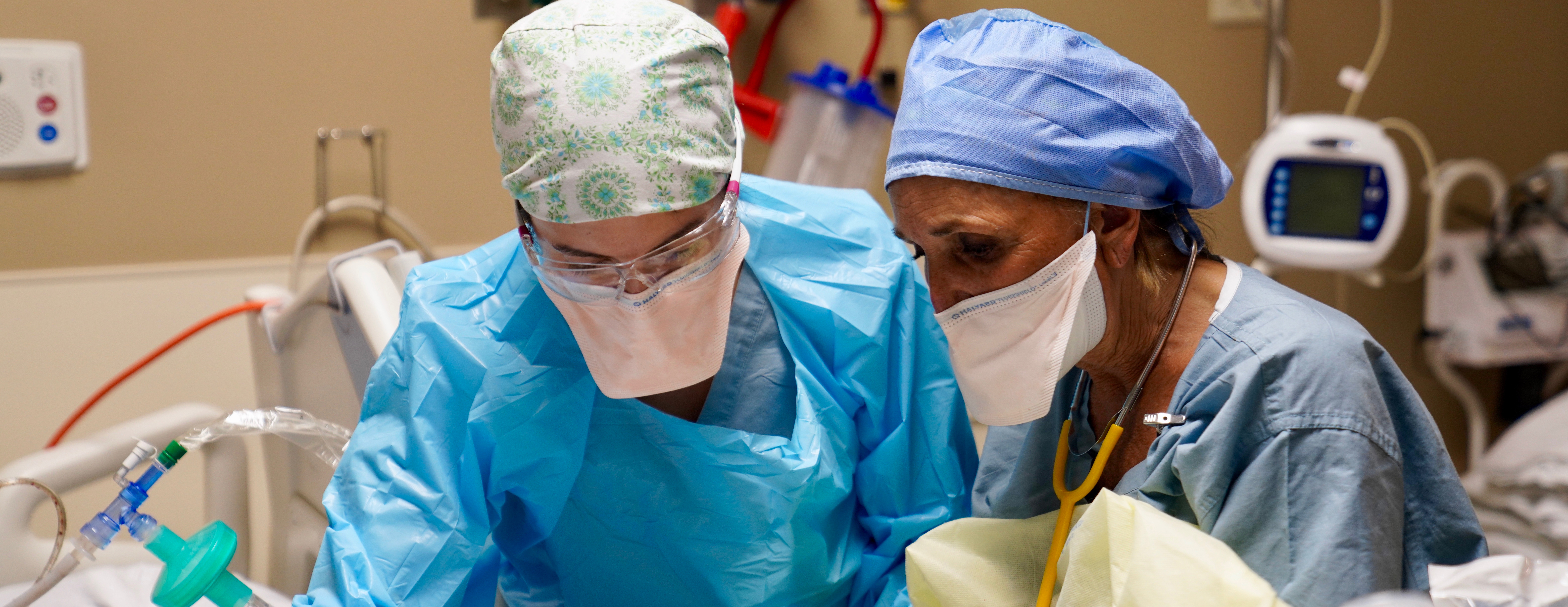 A male and female medical professional in a critical care environment