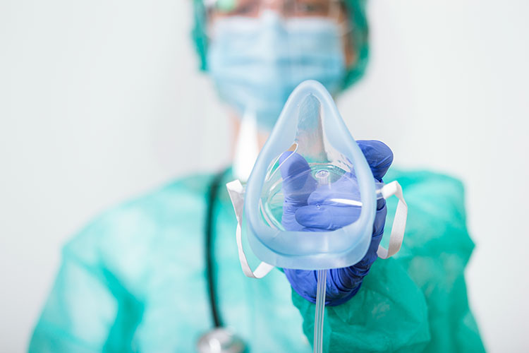 close up of a healthcare professional applying a ventilator mask