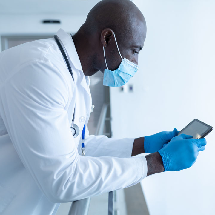 male healthcare professional holding a smartphone